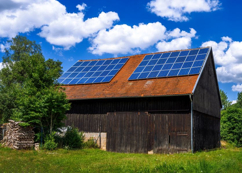 Rural barn converted into off grid solar home with rooftop panels lowering the average monthly electric bill with solar panels.