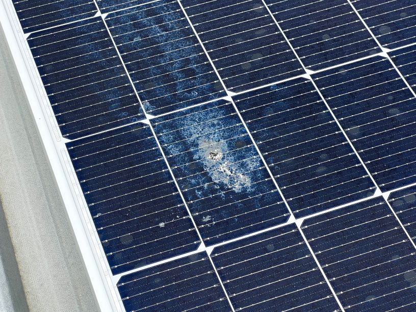 Close-up of a solar panel with heavy dirt and bird droppings reducing efficiency
