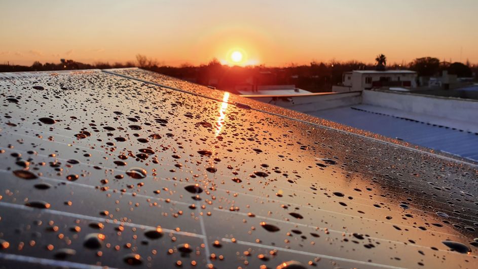 Water-resistant solar panel with droplets reflecting sunset light installed by First Solar installers