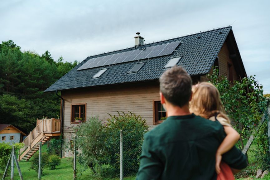 Can Solar Panels Cause Cancer – family looking at their solar-powered home installed by First Solar Installers