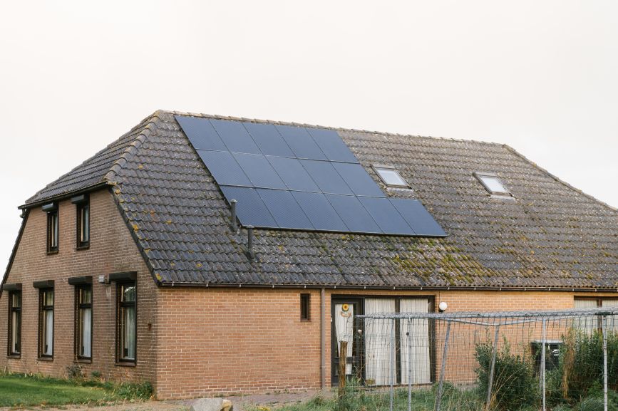 Brick home with custom solar panels installed by First Solar Installers, demonstrating efficient and personalized solar energy design.